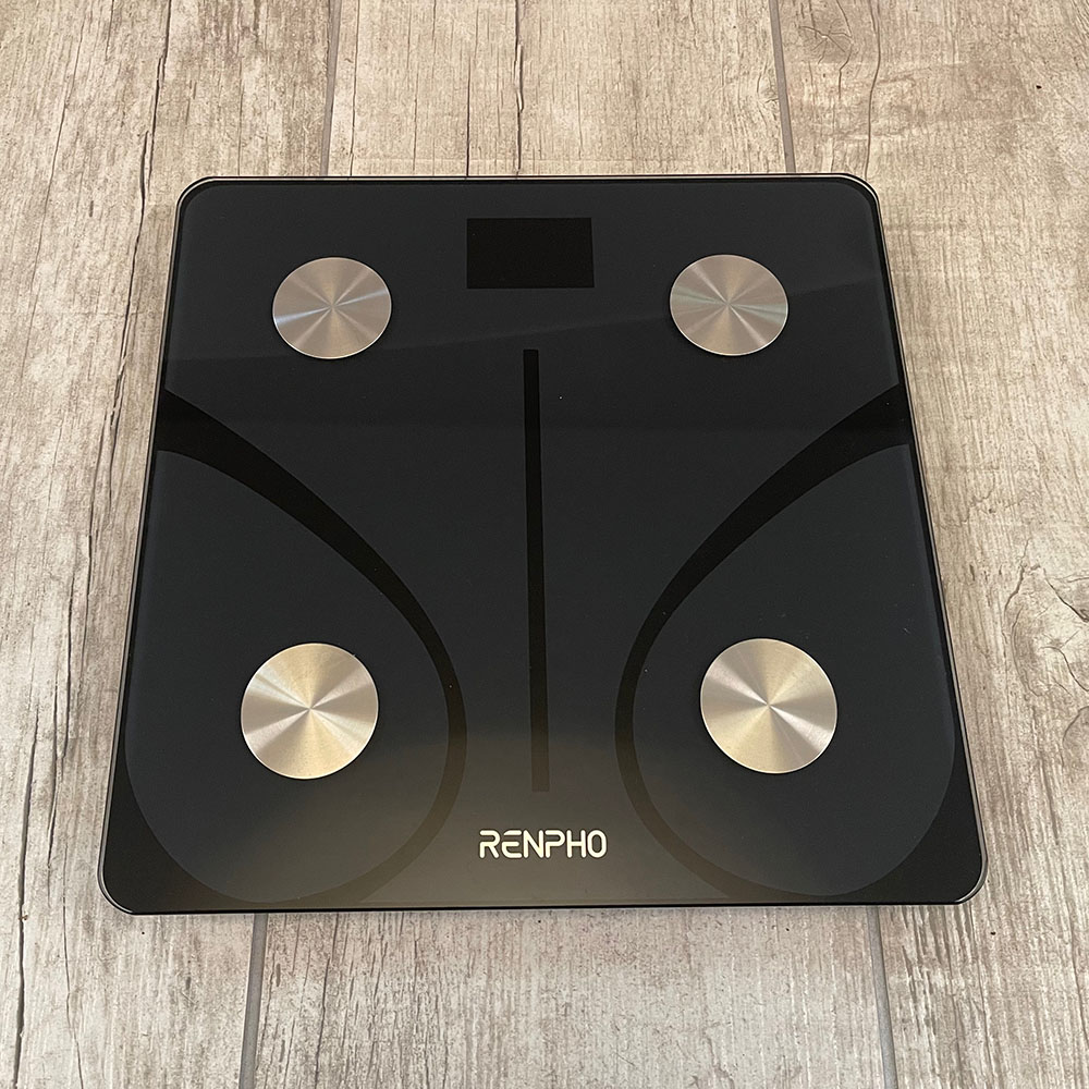 Renpho smart scale in black on gray tile floor